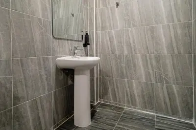 a bathroom with a sink and a mirror at The Hideout Beachfront in Patong Beach
