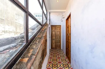 a hallway with a door and a tile floor at Twelve 8 Boutique House in Phuket Town