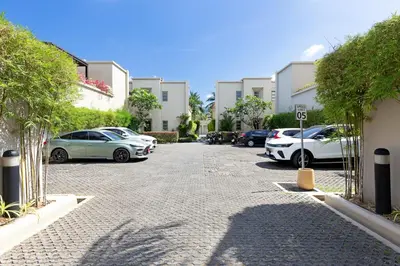 a parking lot with cars parked in front of buildings at The Residence Bangtao Villa 216 in Bang Tao Beach