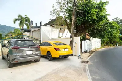 two cars parked on the side of a street at Jungle Villa-private pool, BBQ near Kamala beach in Kamala Beach