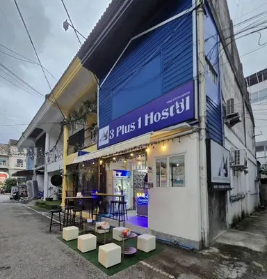a building with a sign on the side of it at 3Plus1 Hostel Patong in Patong Beach