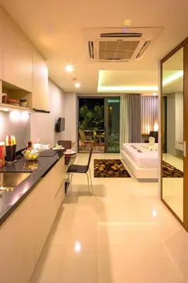 a kitchen and living room with a view of a bedroom at At the tree by fatimah Rawai R315 in Rawai Beach