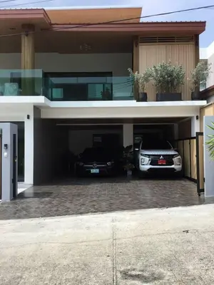 two cars parked in the garage of a house at Mountain breeze villa phuket in Ban Bang Khu