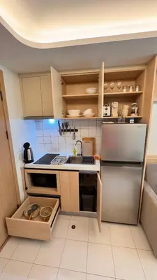 a small kitchen with a refrigerator and a sink at Fantasea Condo Kamala beach 1BR apart B1 in Kamala Beach