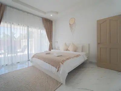 a bedroom with a bed and a large window at Leivi Villa 3 bedrooms in Rawai Beach