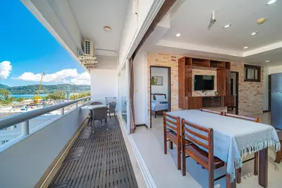 a room with a balcony with a table and chairs at PatongTower\u6b65\u884c\u76f4\u8fbe\u6d77\u6ee9\u9ad8\u901fwifi605S in Patong Beach