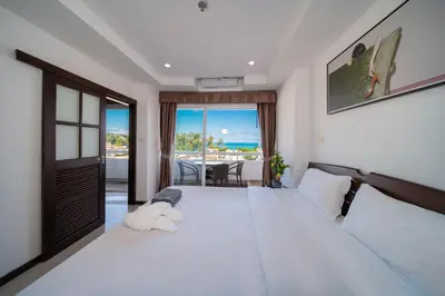 a bedroom with a large white bed with a view of the ocean at PatongTower\u6b65\u884c\u76f4\u8fbe\u6d77\u6ee9\u9ad8\u901fwifi605S in Patong Beach