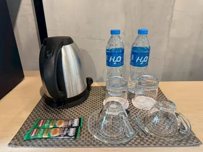 a table with two bottles of water and wine glasses at Aspira Central Patong in Patong Beach