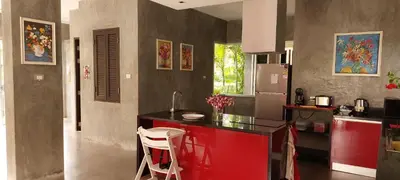 a kitchen with a black counter and a red island at 11 - Peaceful Escape on Naiyang Beach in Nai Yang Beach