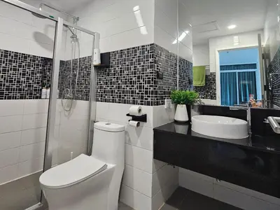 a bathroom with a toilet and a sink at Patong Tower Apartment Family Room Sea View 6 Floor in Patong Beach