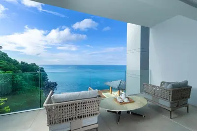 a living room with a view of the ocean at The Aquila Villa in Kamala Beach
