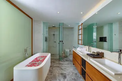 a bathroom with a tub and two sinks and a shower at The Aquila Villa in Kamala Beach
