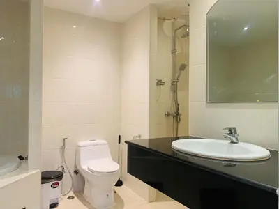 a bathroom with a white toilet and a sink at Rawai Condominium By Wijitra in Phuket Town