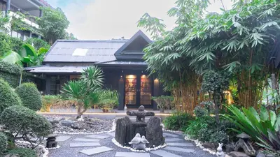 a garden with a fountain in front of a building at Jaokhun Hilltop Kamala, Phuket in Kamala Beach