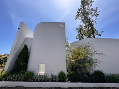 a white building with trees and plants in front of it at MANDLA VILLAS COLLECTION, White Anda Naiharn in Rawai Beach