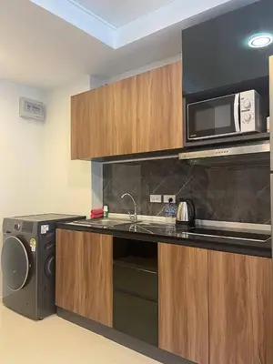 a kitchen with a sink and a microwave at Palm Breeze View in Ban Mai Salae