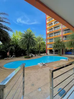 a swimming pool in front of a building at Palm Breeze View in Ban Mai Salae