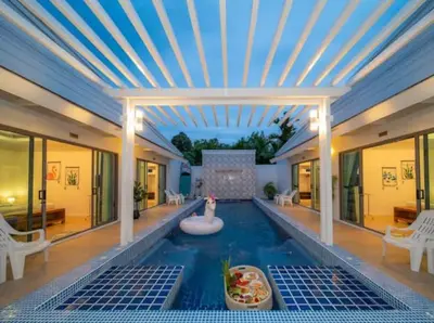 a swimming pool with a swan in the middle of a house at Elegant 4BR Villa with Pool2 in Ban Bang La