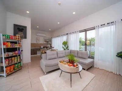 a living room with a couch and a table at Elegant 4BR Villa with Pool2 in Ban Bang La