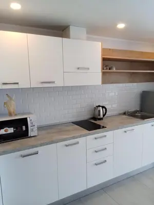 a white kitchen with white cabinets and a sink at Ocean View Apt - 1BR T2-613 in Chalong