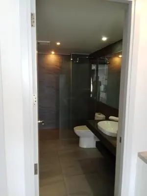a bathroom with a toilet and a sink and a shower at Ocean View Apt - 1BR T2-613 in Chalong