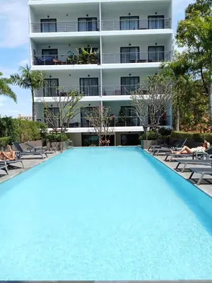 a large swimming pool in front of a building at Modern Condo - 1BR T3-528 in Chalong