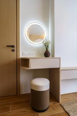 a bathroom with a vanity with a round mirror and a stool at Cozy 1BdR Kamala Beach Pools on the Roof in Kamala Beach