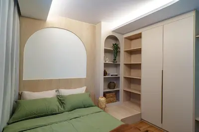 a bedroom with a green bed and a closet at Cozy 1BdR Kamala Beach Pools on the Roof in Kamala Beach