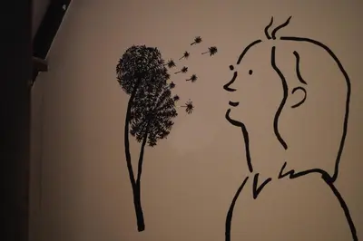 a drawing of a girl with a tree and butterflies at Comfort Hostel Phuket Old Town by MaTong in Phuket Town