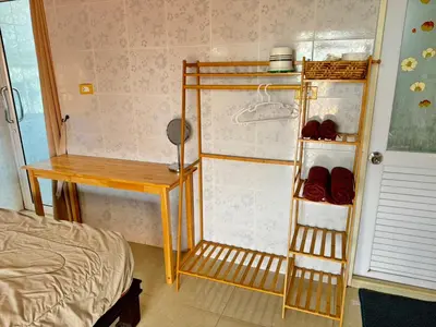 a bedroom with a bed and a desk and a closet at Jampathong mansion in Ban Bo Han