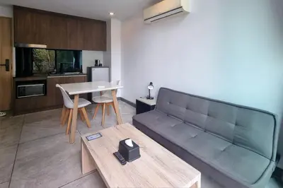 a living room with a couch and a table at Duplex Naiharn UTL A123 - Perfect Stay near Beach in Rawai Beach