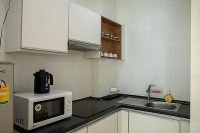 a kitchen with a microwave and a sink at At Sea condo Building C, Klong Muang Beach in Ban Ko Kwang