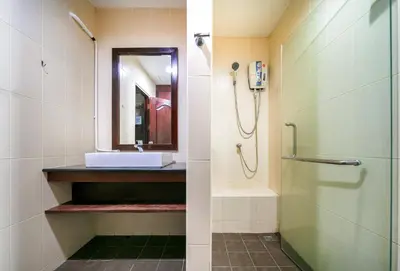 a bathroom with a shower and a sink at EBS Hostel Phuket in Karon Beach
