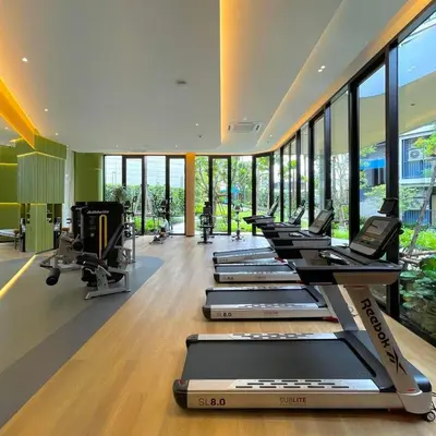 a row of treadmills in a gym with windows at Dcondo Reef Serenity Condo 2 in Phuket Town