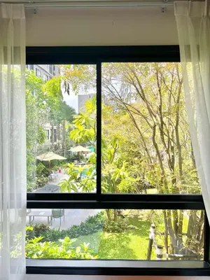 a window with a view of a garden at Dcondo Reef Serenity Condo 2 in Phuket Town