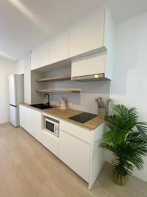 a white kitchen with a sink and a refrigerator at Apartment in Rawai in Ban Saiyuan (1)