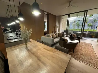 a living room with a table and a couch at Luxury 3-Bedroom Sea View Apartment in MontAzure Kamala in Surin Beach