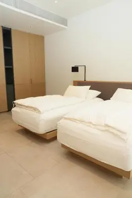 two beds in a room with white sheets at Luxury 3-Bedroom Sea View Apartment in MontAzure Kamala in Surin Beach