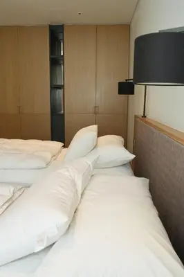 two beds in a hotel room with white pillows at Luxury 3-Bedroom Sea View Apartment in MontAzure Kamala in Surin Beach
