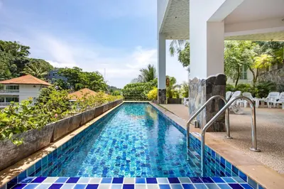 a swimming pool in a villa with a resort at Scenic Kata SeaView Condo O17-1BR just 5 min Drive to Kata Beach in Karon Beach