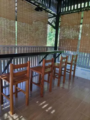 a group of chairs and a table in a room at Baan Sangchai Beach in Ko Bon