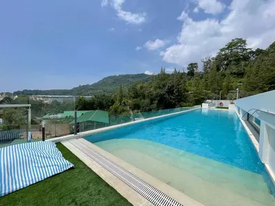 a large swimming pool with a view of a mountain at Two-bedrooms apartments with kitchen in Phuket Town