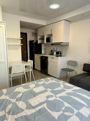 a room with a kitchen and a living room with a bed at New apartment with mountain view in Ban Mai Salae