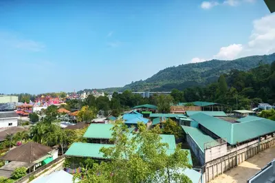 a view of a town with mountains in the background at Kamala Beach View 1 BdR Roof Pool 500 mbps WiFi in Kamala Beach