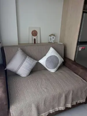 two pillows sitting on a couch in a room at One-bedroom apartments with kitchen in Phuket Town