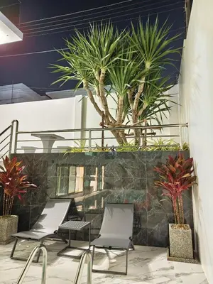 a group of chairs and palm trees on a wall at Mountain breeze villa phuket in Ban Bang Khu