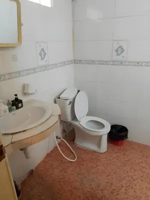 a bathroom with a toilet and a sink at XX GO INN Patong Beach Phuket in Patong Beach