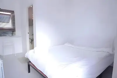 a white bed in a room with a window at XX BAO Patong Beach Phuket - เบาป่าตองบีช in Patong Beach