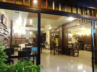 a restaurant with tables and chairs inside of it at Athome Hotel Nanai 8 in Patong Beach
