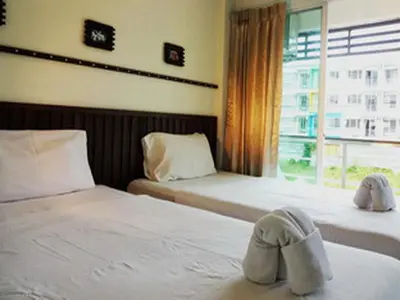 a bedroom with two beds with shoes on them at Athome Hotel Nanai 8 in Patong Beach